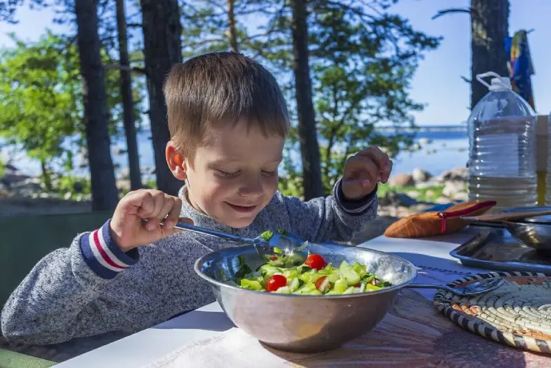 kid eating a bowl of salad 